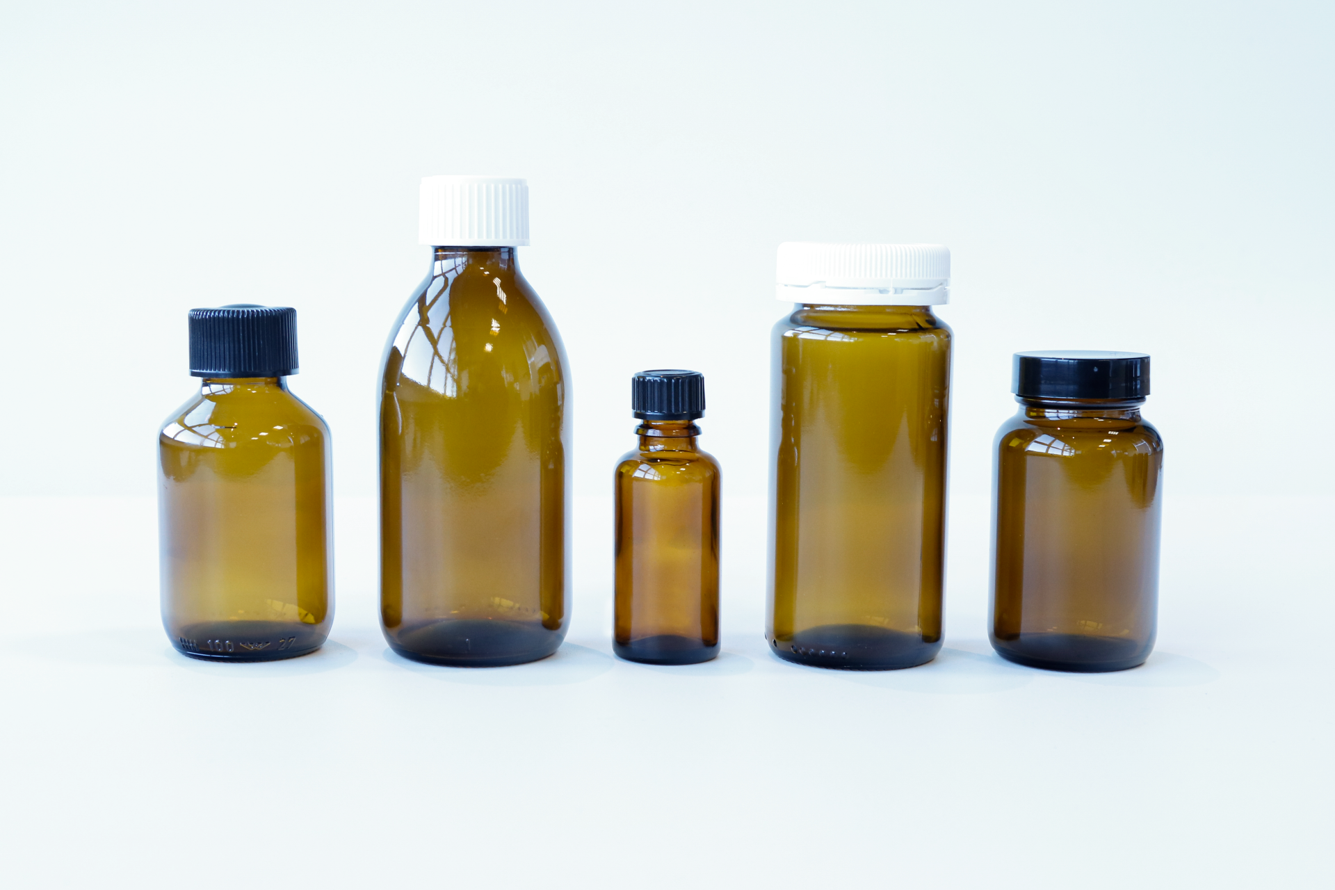 Braunglas Flaschen in verschiedenen Größen und Ausführungen mit schwarzen und weißen Deckeln